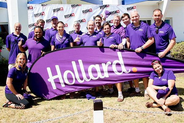 The Hollard RiskAfrica Team standing proudly with a Hollard Banner
