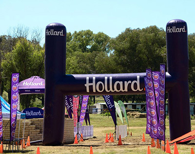 The 3 Mountains Challenge finish-line marked by a giant Hollard-branded inflatable.