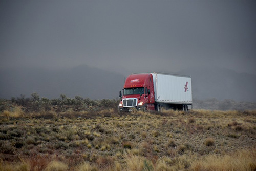 An "Empty Trips" truck driving in fields
