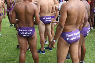 Back of Speedo reading "run cancer out of town"