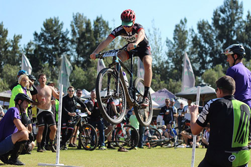 An airborne cyclist crossing the finishing line at the Hollard Juma Event